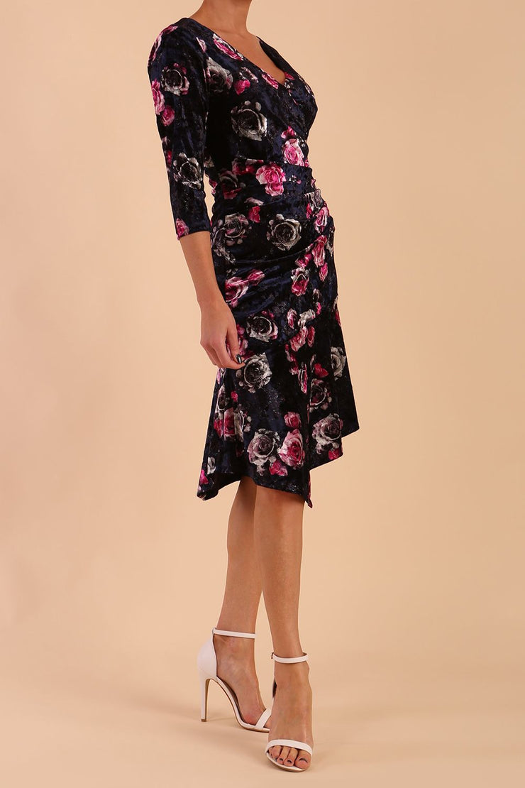 Model wearing Diva Catwalk Vella Asymmetric Dress 3/4 sleeve asymmetric hemline with v neckline in Rose Blossom Print side
