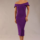 brunette model wearing diva catwalk juilet midaxi pencil sleeveless off shoulder dress with open neck and folded collar in colour passion purple front