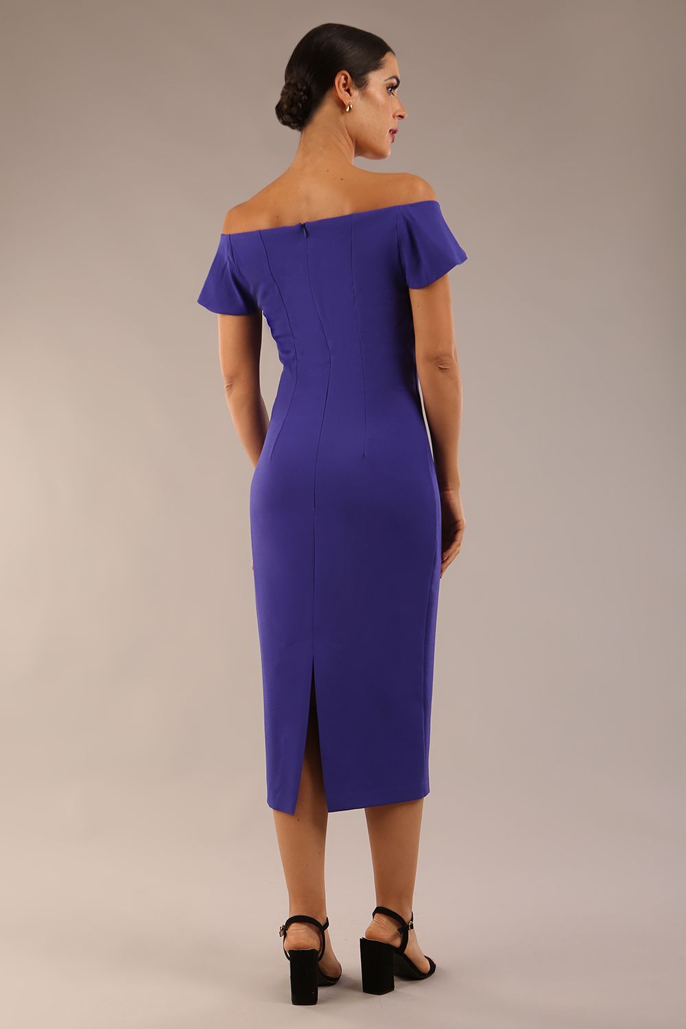 brunette model wearing diva catwalk juilet midaxi pencil sleeveless off shoulder dress with open neck and folded collar in colour spectrum indigo back