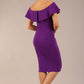 brunette model wearing diva catwalk pencil dress with off shoulder frilled front and bardot neckline in passion purple colour back