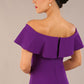 brunette model wearing diva catwalk pencil dress with off shoulder frilled front and bardot neckline in passion purple colour back
