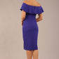 brunette model wearing diva catwalk pencil dress with off shoulder frilled front and bardot neckline in spectrum indigo  colour back