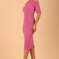 model is wearing diva catwalk solway pencil dress cold shoulder detail and rounded neckline in Begonia pink front side