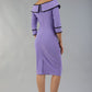 model wearing a diva catwalk Paige Bi-Stretch Dress with 3/4 sleeve, knee length, Fold over off-shoulder neckline with bow detail and with Contrast piping on sleeve cuffs and neckline in Lilac Wisteria and black colour