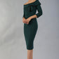 model wearing a diva catwalk Paige Bi-Stretch Dress with 3/4 sleeve, knee length, Fold over off-shoulder neckline with bow detail and with Contrast piping on sleeve cuffs and neckline in Forest Green and black colour