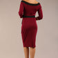 brunette model wearing diva catwalk luma pencil skirt dress with contrasting bow off shoulder with sleeves in blissful burgundy back