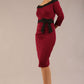 brunette model wearing diva catwalk luma pencil skirt dress with contrasting bow off shoulder with sleeves in blissful burgundy front