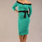 model wearing diva catwalk luma pencil skirt dress with contrasting bow off shoulder with sleeves in Emerald Green front