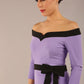 brunette model wearing diva catwalk luma pencil skirt dress with contrasting bow off shoulder with sleeves in Violet Bloom front