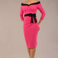 model wearing diva catwalk luma pencil skirt dress with contrasting bow off shoulder with sleeves in hibiscus pink front