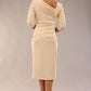 model wearing a diva catwalk Rococo 3/4 Sleeved Pencil Dress with asymmetric neckline with pleating details and 3/4 sleeves length and knee length in beige colour