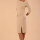 model wearing a diva catwalk Rococo 3/4 Sleeved Pencil Dress with asymmetric neckline with pleating details and 3/4 sleeves length and knee length in beige colour