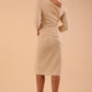 model wearing a diva catwalk Rococo 3/4 Sleeved Pencil Dress with asymmetric neckline with pleating details and 3/4 sleeves length and knee length in beige colour