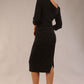 model wearing a diva catwalk Rococo 3/4 Sleeved Pencil Dress with asymmetric neckline with pleating details and 3/4 sleeves length and knee length in black colour