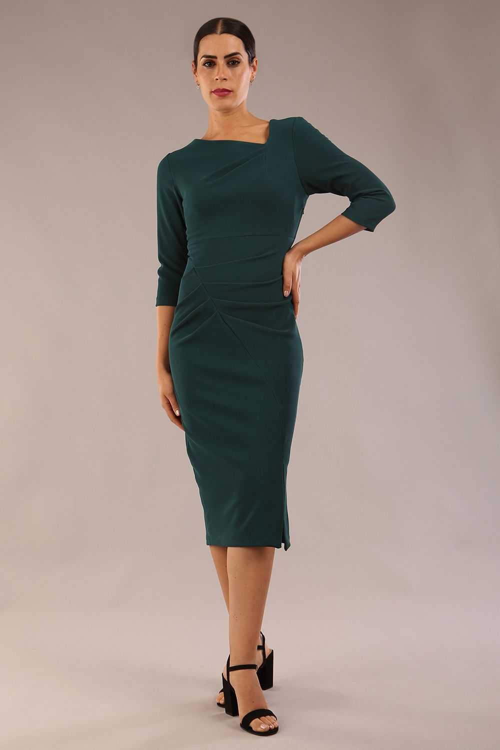 model is wearing a diva catwalk Amity Asymmetric Neckline Pleated front and back with 3/4 sleeves and front vent pencil Dress in Green Gables colour