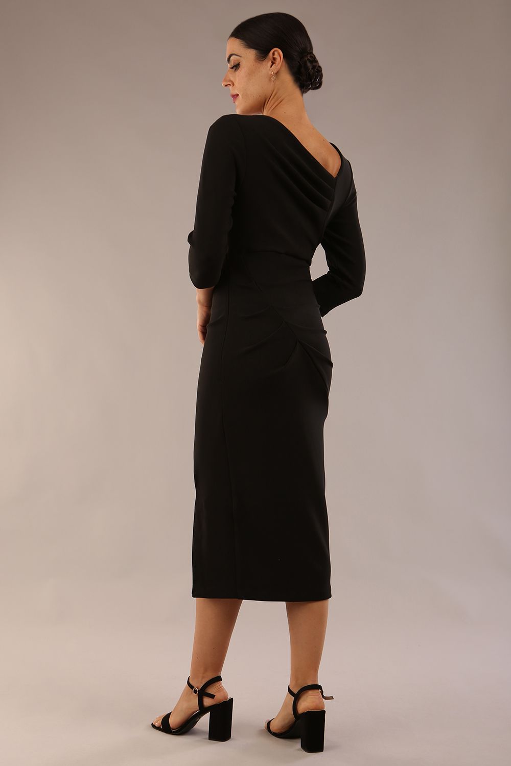 model is wearing a diva catwalk Amity Asymmetric Neckline Pleated front and back with 3/4 sleeves and front vent pencil Dress in Black colour