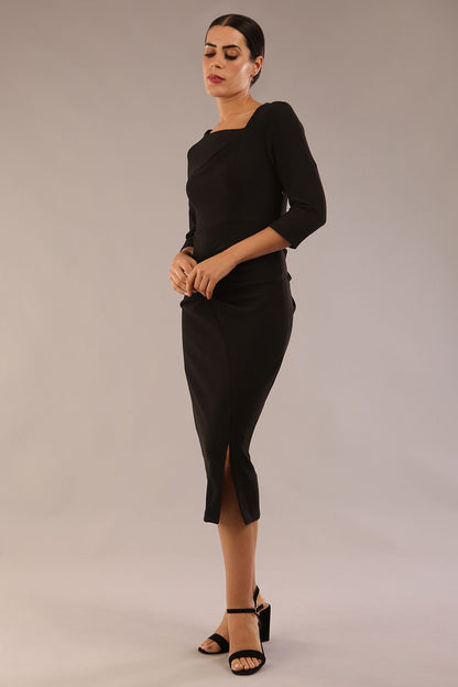 model is wearing a diva catwalk Amity Asymmetric Neckline Pleated front and back with 3/4 sleeves and front vent pencil Dress in Black colour