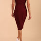 Model wearing Diva Catwalk Polly Rounded Neckline Pencil Cap Sleeve Dress with pleating across the tummy area in Cabaret Burgundy back
