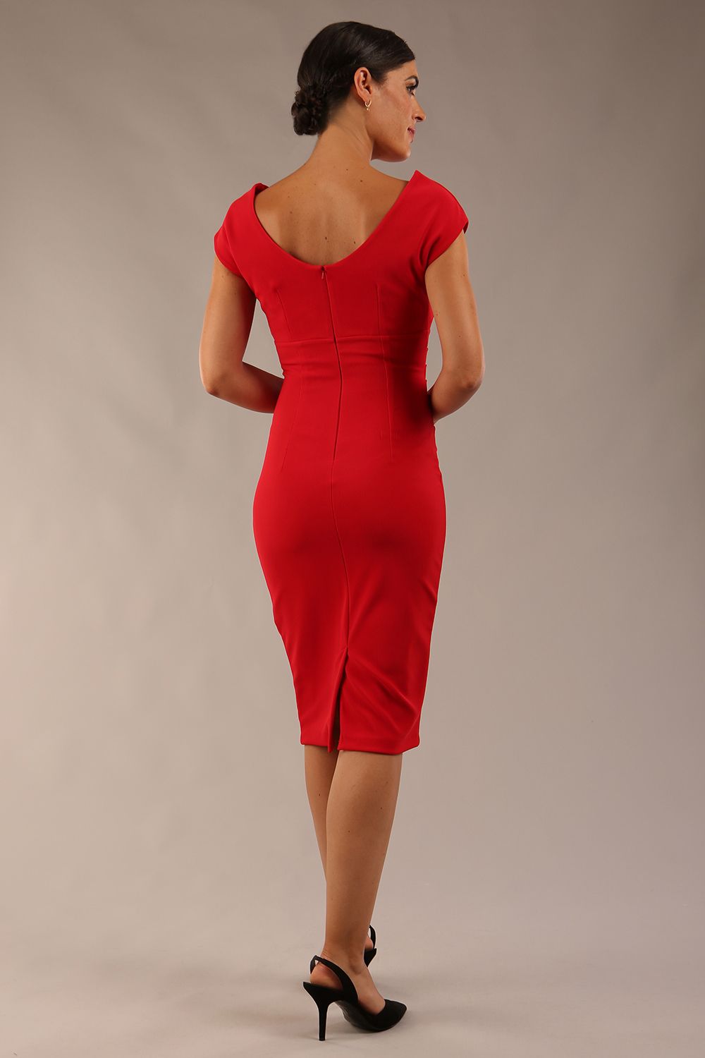 Model wearing Diva Catwalk Polly Rounded Neckline Pencil Cap Sleeve Dress with pleating across the tummy area in True Red back