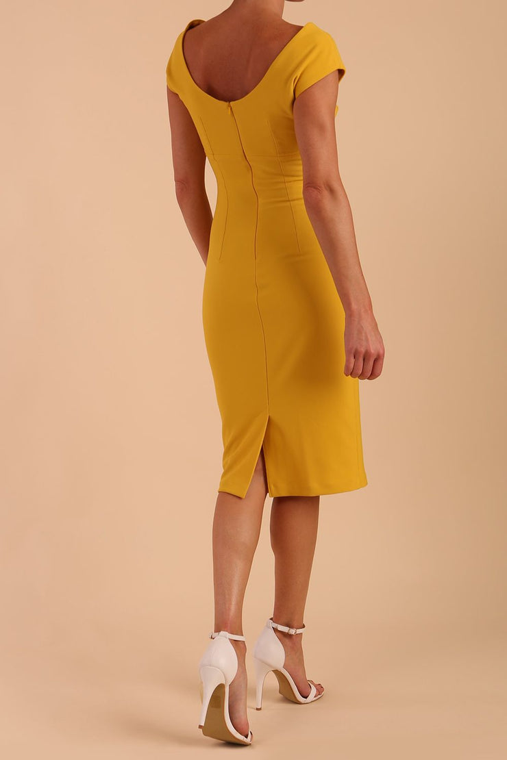 Model wearing Diva Catwalk Polly Rounded Neckline Pencil Cap Sleeve Dress with pleating across the tummy area in Mustard Yellow back