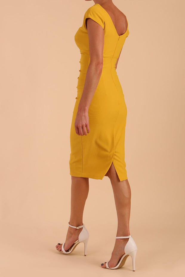 Model wearing Diva Catwalk Polly Rounded Neckline Pencil Cap Sleeve Dress with pleating across the tummy area in Mustard Yellow back side