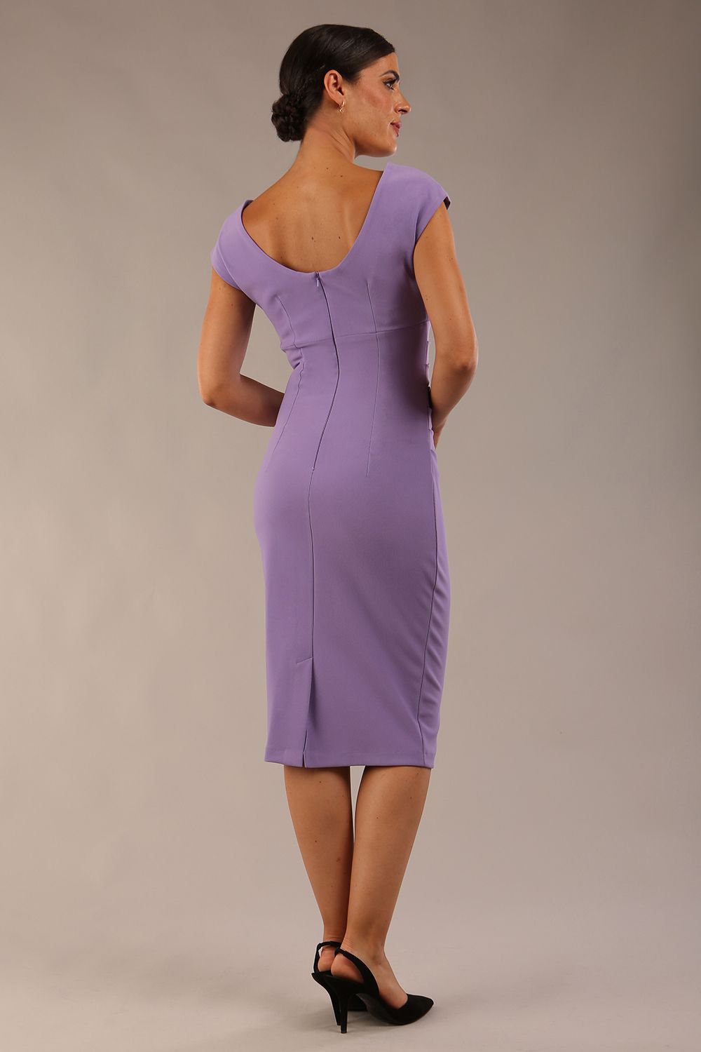 model is wearing diva catwalk polly cap sleeve pencil dress with rounded neckline at the front and deep lowered rounded cutout at the back in chalk purple back