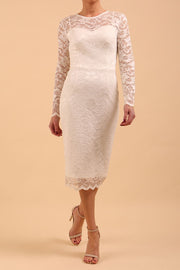 Model wearing a diva catwalk Montana Lace Dress with long lace sleeve and knee length with round lace neckline in Ivory Cream colour front 