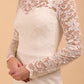 Model wearing a diva catwalk Montana Lace Dress with long lace sleeve and knee length with round lace neckline in Ivory Cream colour front side sleeves details