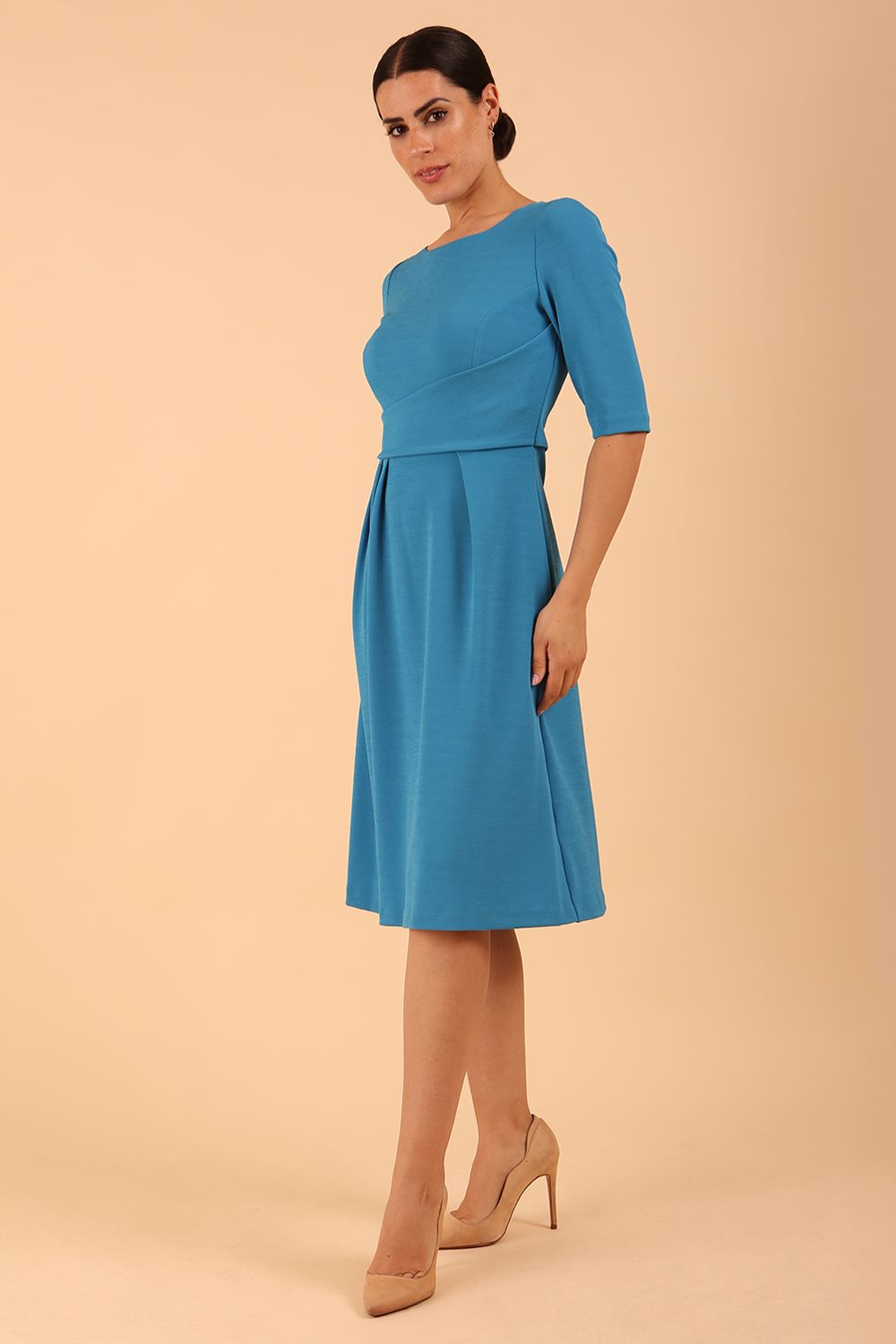 model wearing a Tarifa Elbow Sleeve Swing Dress 3/4 sleeves and knee length in malibu blue colour
