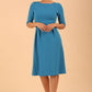 model wearing a Tarifa Elbow Sleeve Swing Dress 3/4 sleeves and knee length in malibu blue colour