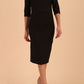 model wearing seed couture royale pencil skirt dress with pleating across the tummy area with rounded neckline with a split in the middle and 3 4 sleeve in Black colour front