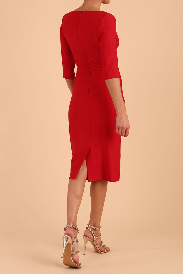 model wearing seed couture royale pencil skirt dress with pleating across the tummy area with rounded neckline with a split in the middle and 3 4 sleeve in Salsa Red colour Back