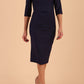 model wearing seed couture royale pencil skirt dress with pleating across the tummy area with rounded neckline with a split in the middle and 3 4 sleeve in Navy Blue colour front