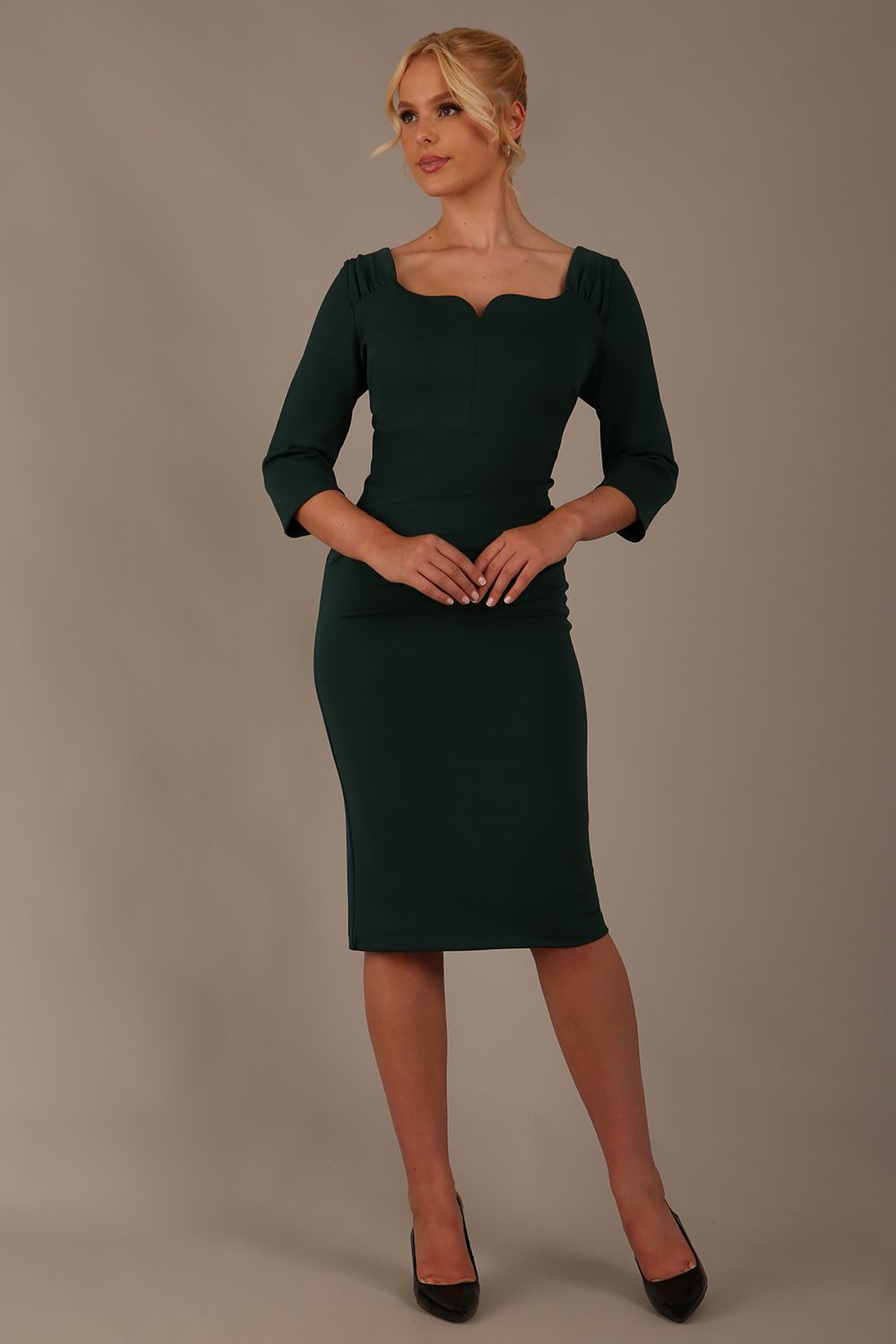 model is wearing a diva catwalk hathaway sweetheart neckline pencil dress in forest green against a plain background front view
