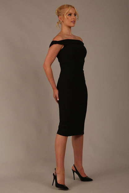 Model wearing the Diva Cloud Luxury Ripple Crepe cloud off-shoulder dress  design in black front image against a plain background