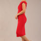 brunette model wearing a diva catwalk cloud pencil fitted flattering dress off shoulder sleeveless with detail with pleating around the front in scarlet red side