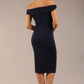 brunette model wearing a diva catwalk cloud pencil fitted flattering dress off shoulder sleeveless with detail with pleating around the front in navy blue back
