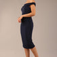 brunette model wearing a diva catwalk cloud pencil fitted flattering dress off shoulder sleeveless with detail with pleating around the front in navy blue front