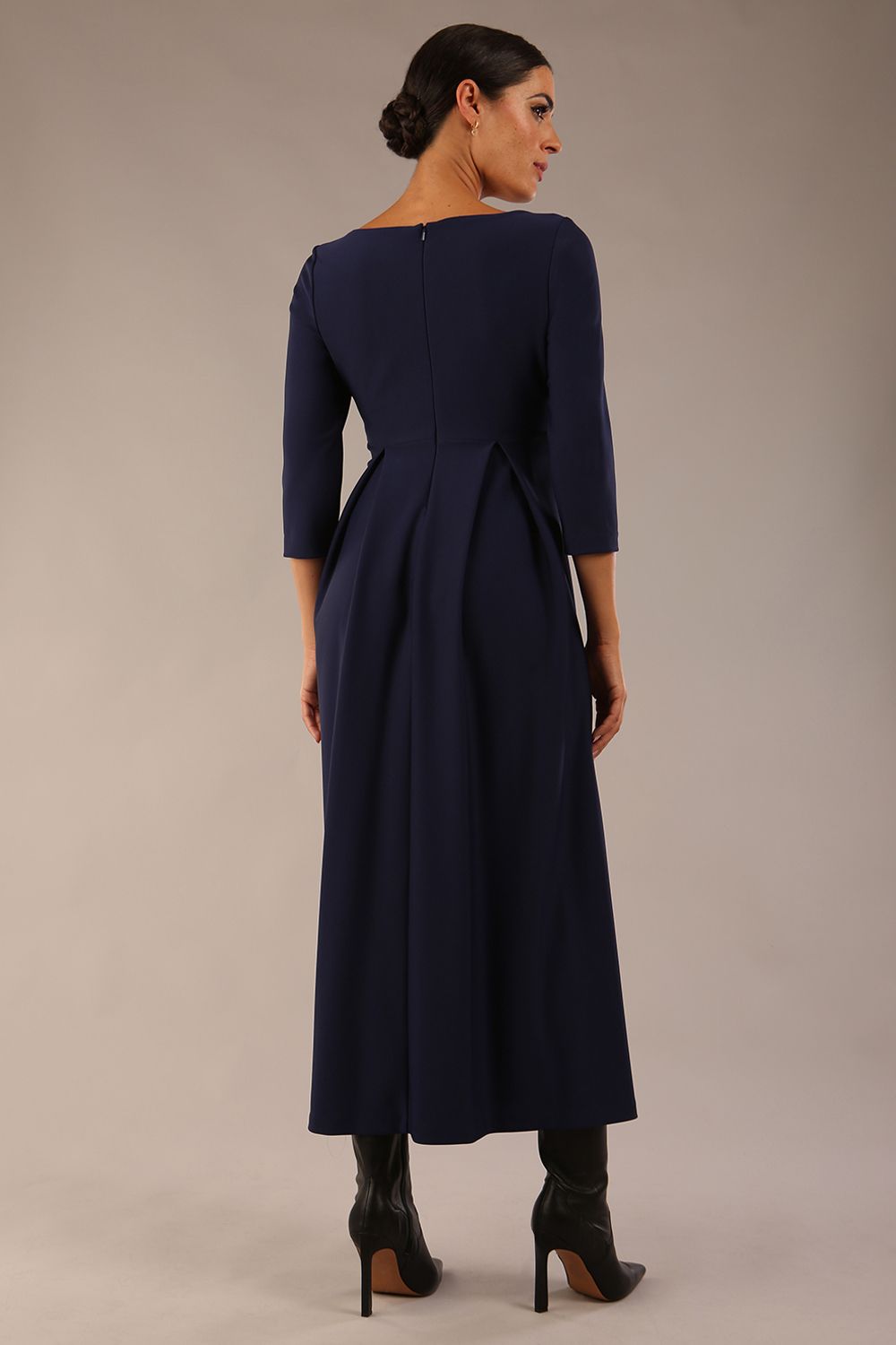 Brunette Model is wearing 3/4 sleeve sweetheart neckline swing navy blue dress