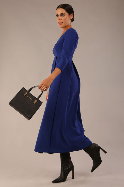 Brunette Model is wearing 3/4 sleeve sweetheart neckline swing cobalt blue dress