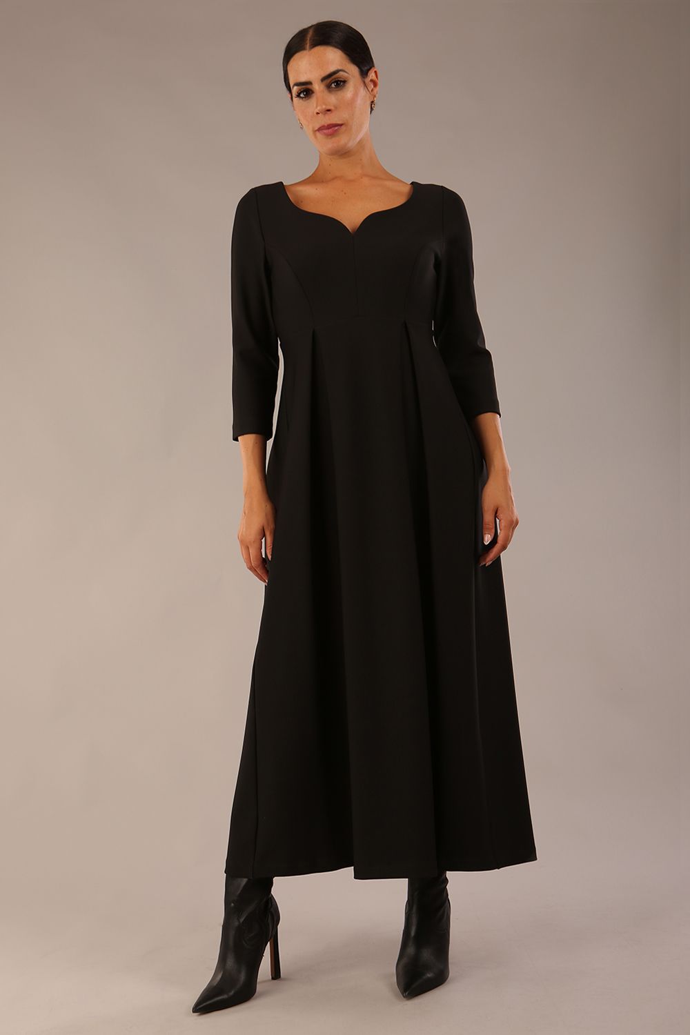 Brunette Model is wearing 3/4 sleeve sweetheart neckline swing black dress