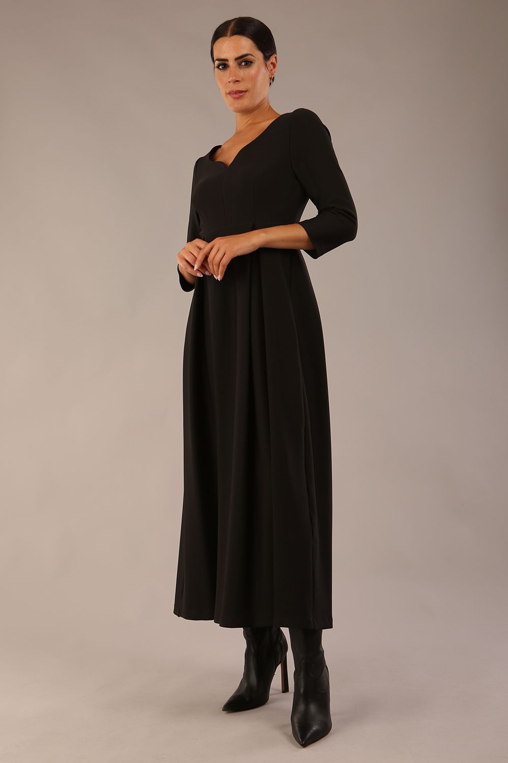 Brunette Model is wearing 3/4 sleeve sweetheart neckline swing black dress