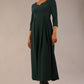 Brunette Model is wearing 3/4 sleeve sweetheart neckline swing forest green dress