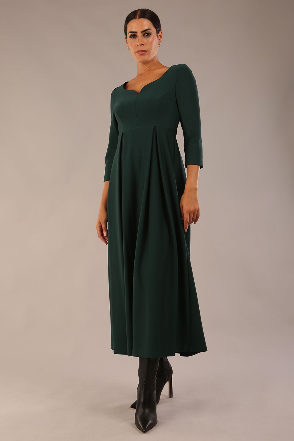 Brunette Model is wearing 3/4 sleeve sweetheart neckline swing forest green dress