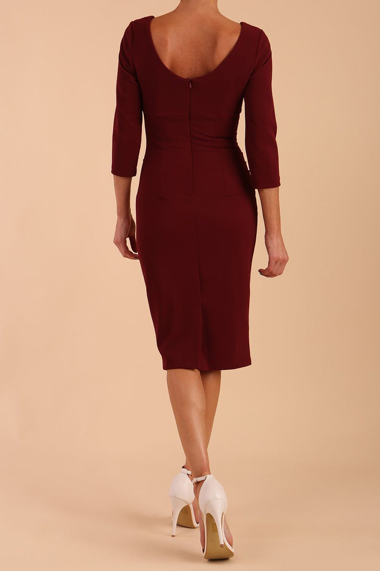 model is wearing diva catwalk polly sleeved pencil dress with low rounded neckline at the back in Cabaret Burgundy back