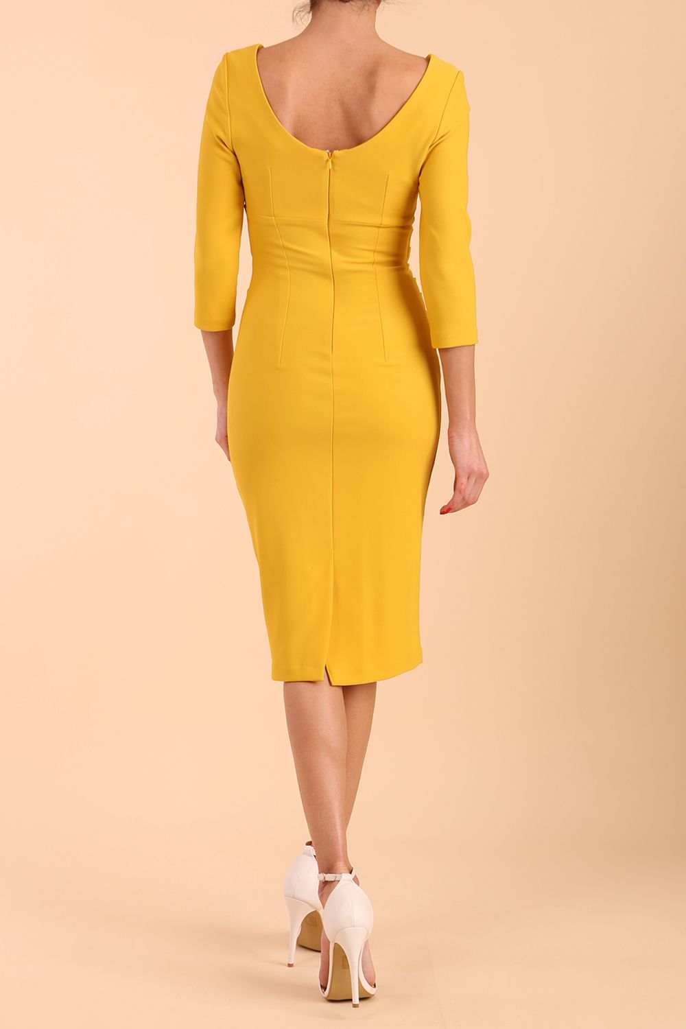 model is wearing diva catwalk polly sleeved pencil dress with low rounded neckline at the back in Mustard Yellow back