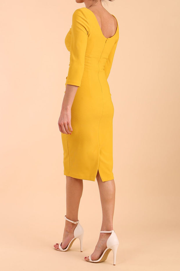 model is wearing diva catwalk polly sleeved pencil dress with low rounded neckline at the back in Mustard Yellow side back