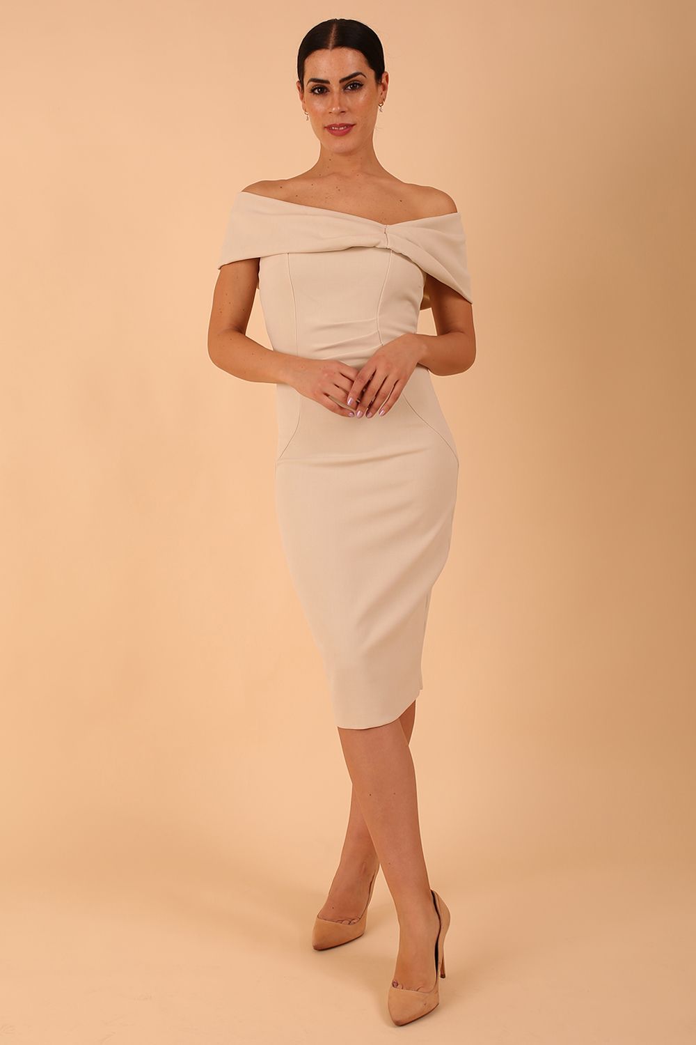  model is wearing diva catwalk mariposa pencil dress with Detailed Bardot neckline with fold-over detail and pleated at waist area in sandshell beige front