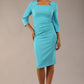 model is wearing diva catwalk quatro sleeved pencil dress with asymmetric wide cut our neckline in azure blue front