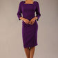 model is wearing diva catwalk quatro sleeved pencil dress with asymmetric wide cut our neckline in deep purple front